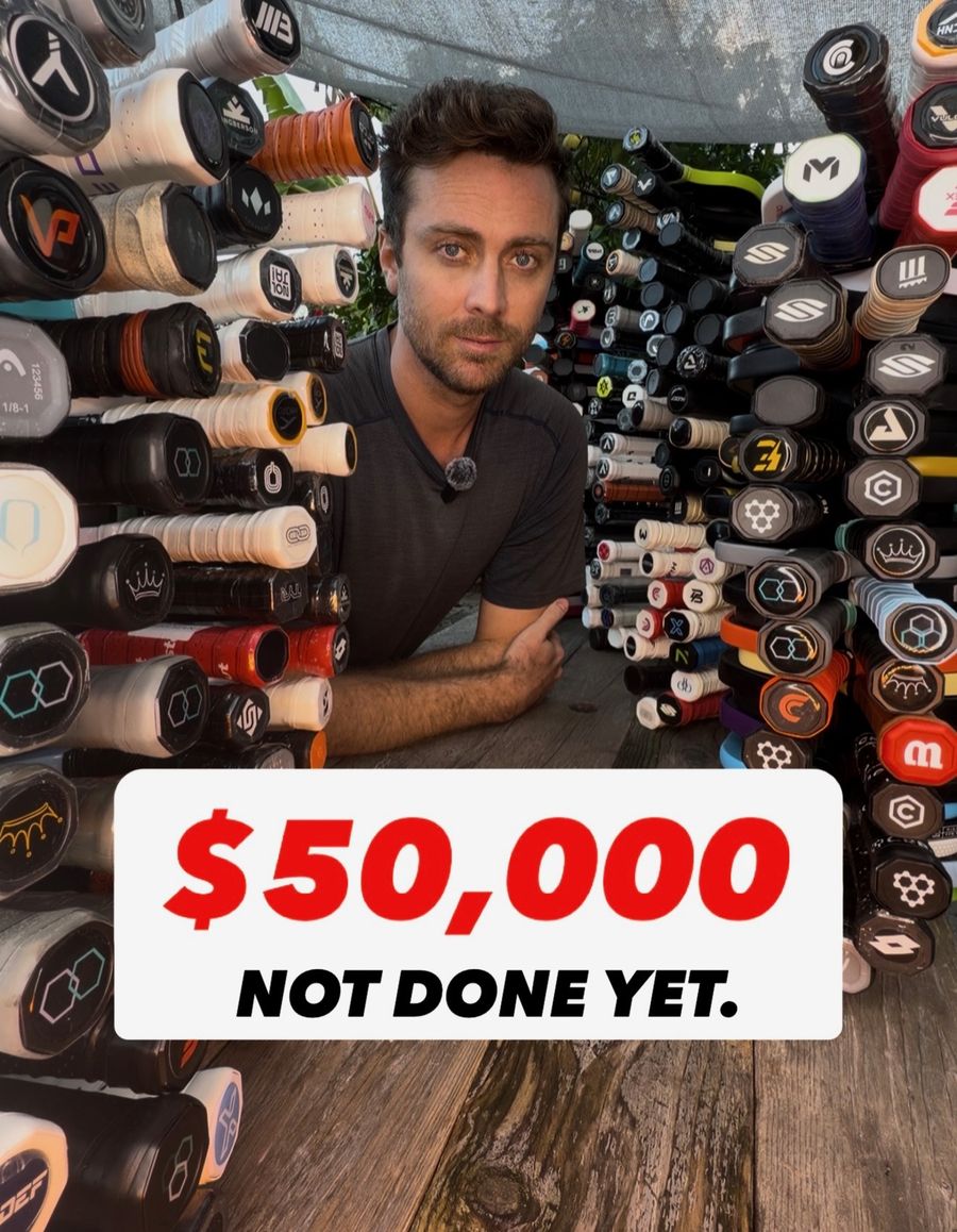Troy Hamner in front of a wall of donated pickleball paddles